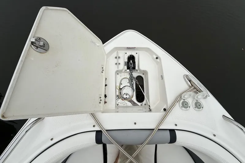 Slide: The Image of 2021 Chaparral 300 OSX boat anchor compartment with open hatch and ropes. - 19