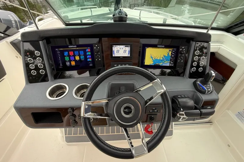 Slide: The Image of 2021 Chaparral 300 OSX boat dashboard with advanced navigation displays and controls. - 20