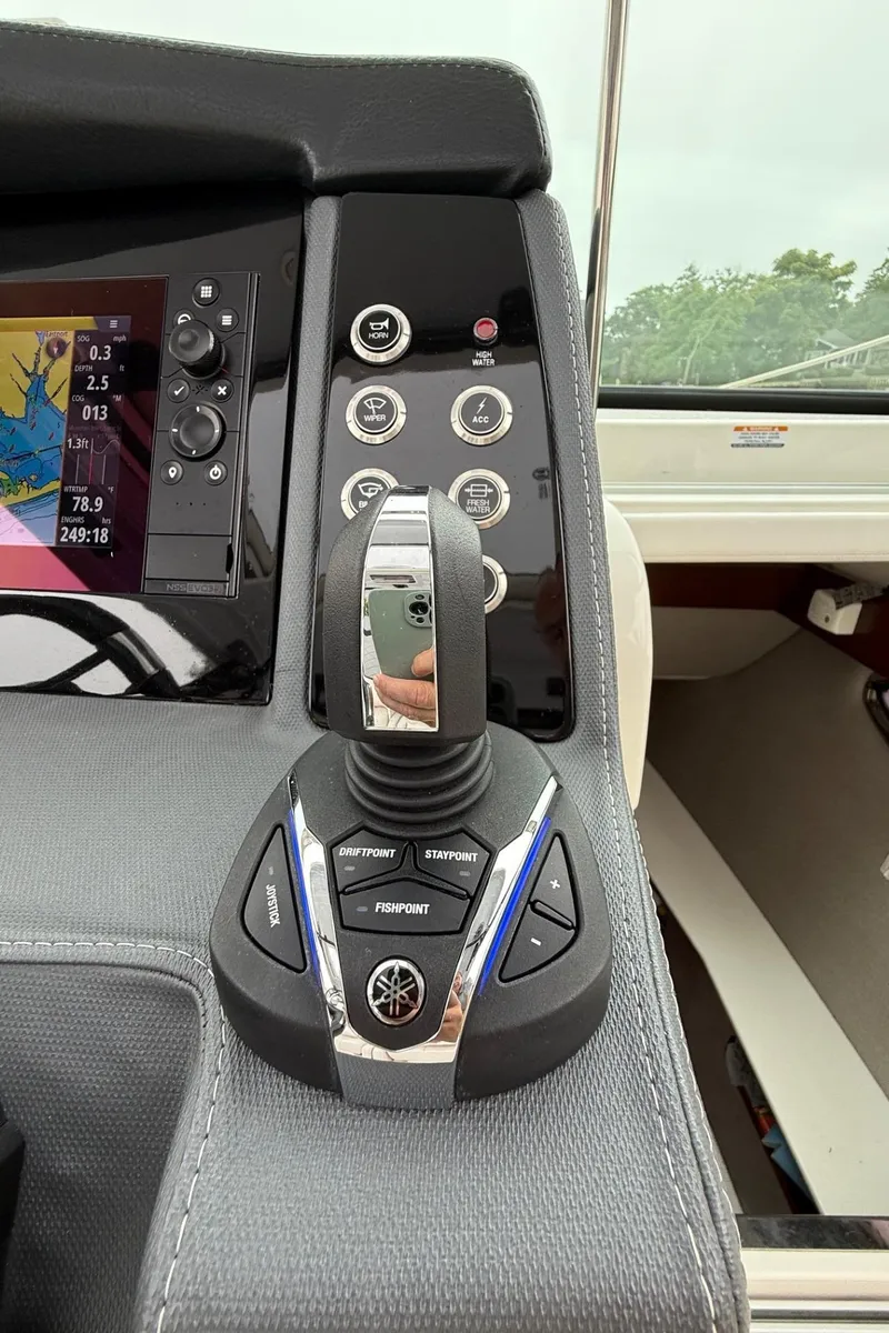 Slide: The Image of Control panel of 2021 Chaparral 300 OSX boat with joystick and navigation display. - 21