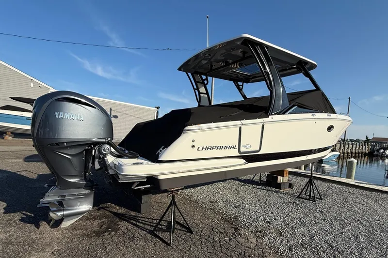 Slide: The Image of 2021 Chaparral 300 OSX boat with Yamaha engine on display at a marina. - 3