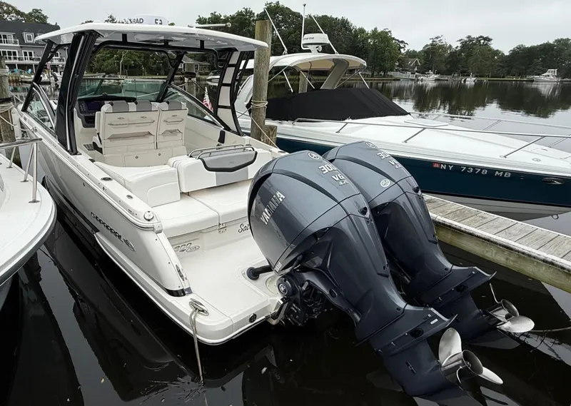 Slide: The Image of 2021 Chaparral 300 OSX boat docked with dual Yamaha outboard engines. - 6