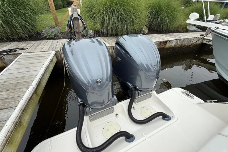 Slide: The Image of 2021 Chaparral 300 OSX with dual Yamaha outboard engines docked by wooden pier. - 7