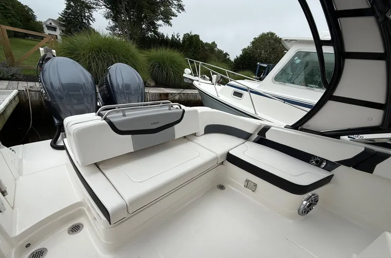 Slide: The Image of 2021 Chaparral 300 OSX boat interior with seating and dual engines. - 8