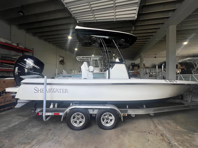 Slide: The Image of 2022 ShearWater 250 Carolina boat on trailer in storage facility. - 1