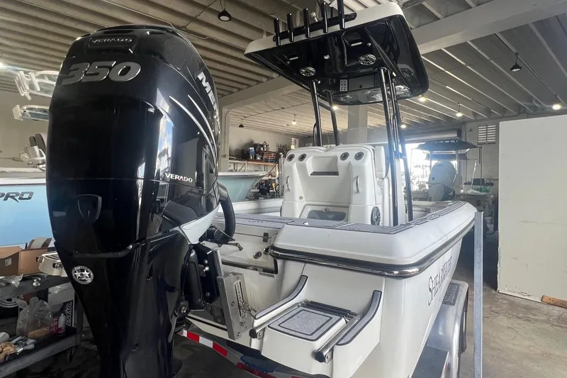 Slide: The Image of 2022 ShearWater 250 Carolina boat with Mercury 350 Verado engine in a garage. - 6