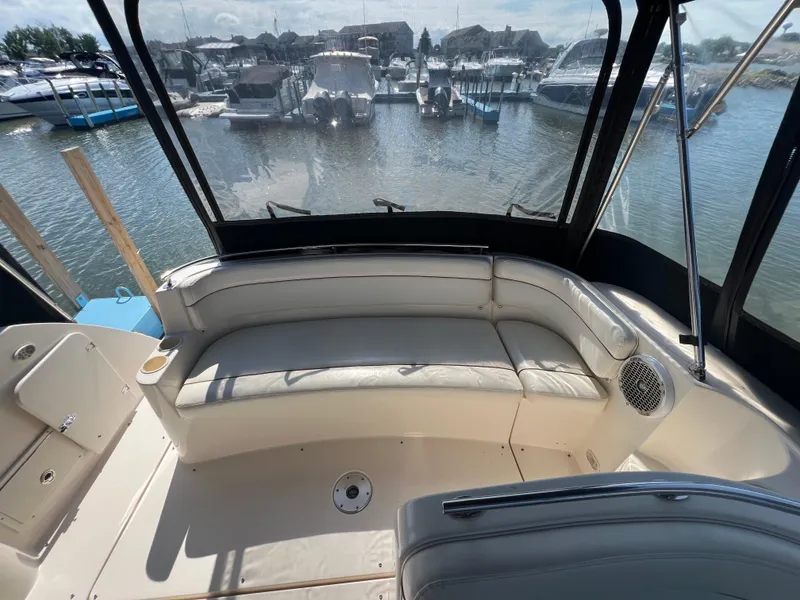 Slide: The Image of 2003 Rinker 312 Fiesta Vee boat interior with seating, docked at marina. - 10