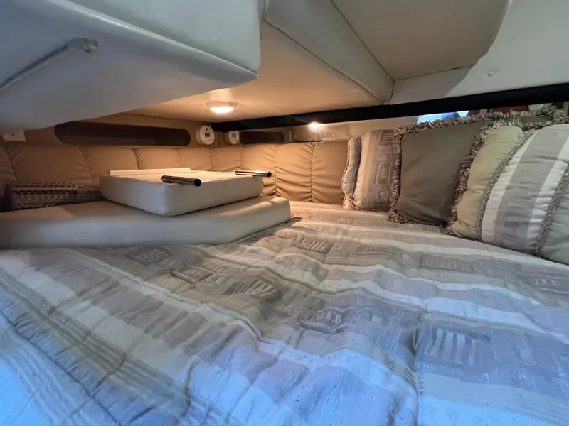 Slide: The Image of Cozy cabin interior of 2003 Rinker 312 Fiesta Vee with plush bedding and cushions. - 17