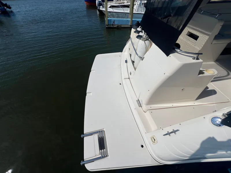 Slide: The Image of 2003 Rinker 312 Fiesta Vee boat stern with swim platform and ladder. - 3