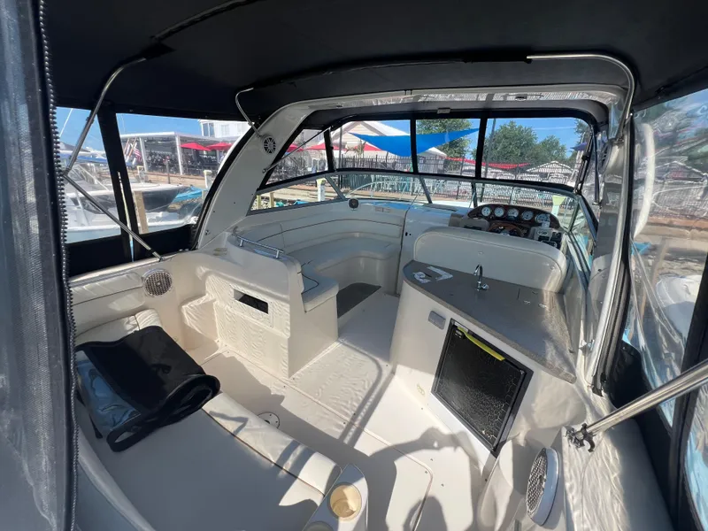 Slide: The Image of Interior of a 2003 Rinker 312 Fiesta Vee boat with seating and dashboard. - 4