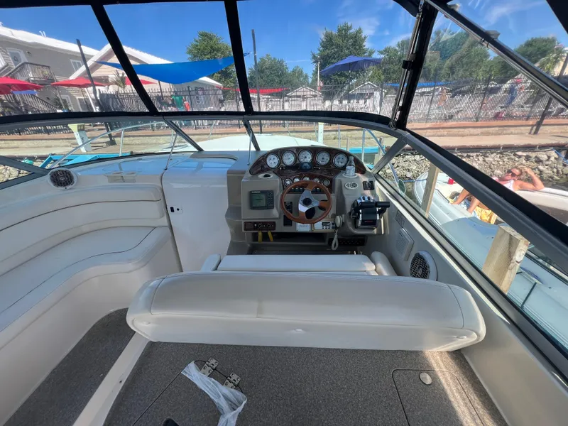 Slide: The Image of 2003 Rinker 312 Fiesta Vee boat cockpit with steering wheel and dashboard controls. - 6