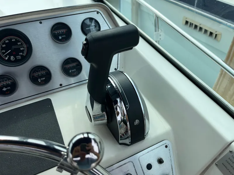 Slide: The Image of 1986 Tiara Yachts Continental dashboard with throttle and gauges. - 12