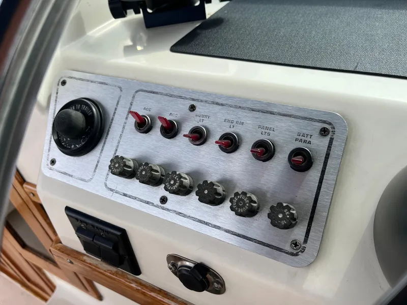 Slide: The Image of Control panel of a 1986 Tiara Yachts Continental boat with switches and knobs. - 13