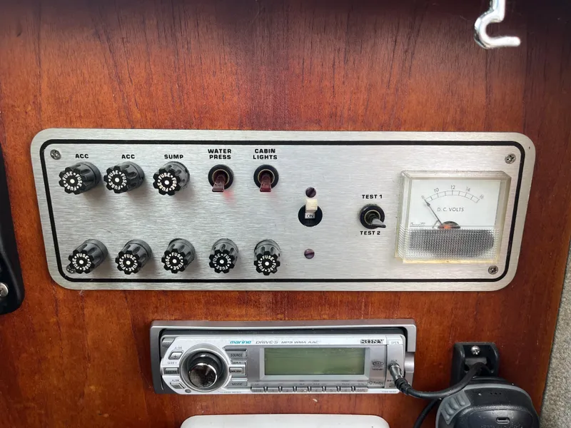 Slide: The Image of 1986 Tiara Yachts Continental control panel with switches, voltmeter, and marine radio. - 16