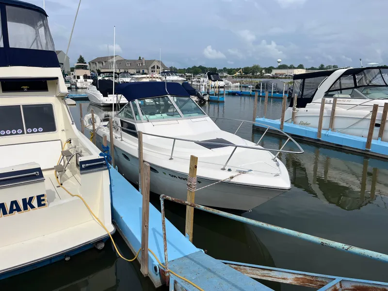 Slide: The Image of 1986 Tiara Yachts Continental docked at marina, surrounded by other boats. - 2