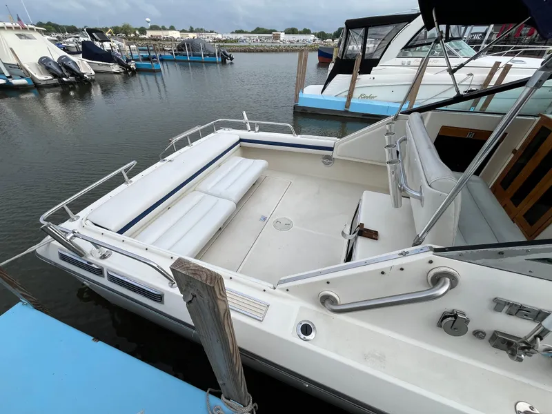 Slide: The Image of 1986 Tiara Yachts Continental boat docked, featuring spacious seating and sleek design. - 3