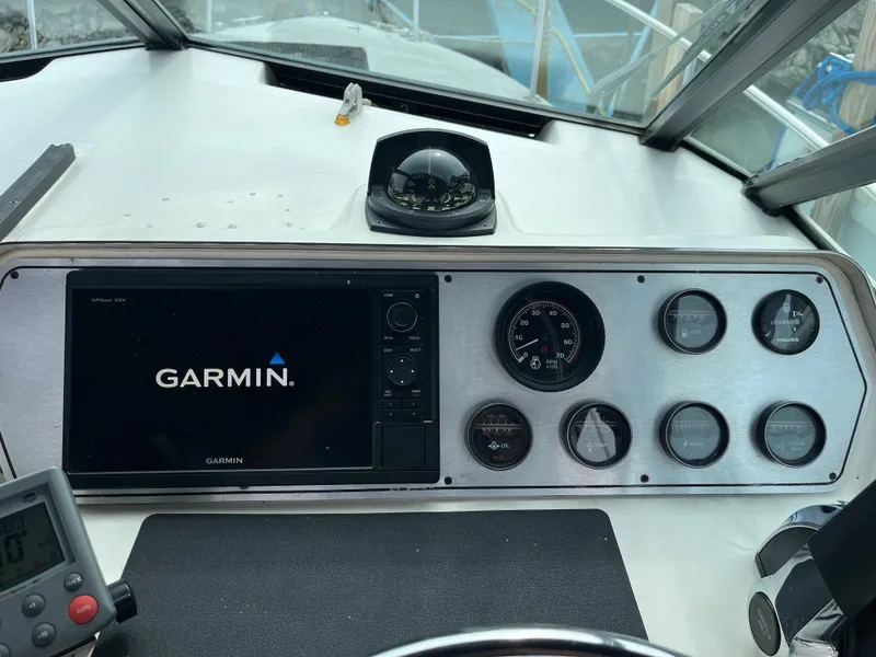 Slide: The Image of 1986 Tiara Yachts Continental dashboard with Garmin GPS and analog gauges. - 7