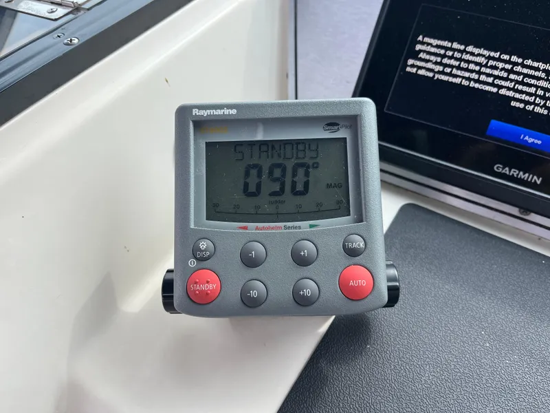 Slide: The Image of Raymarine autopilot display on 1986 Tiara Yachts Continental, showing 090° heading. - 9