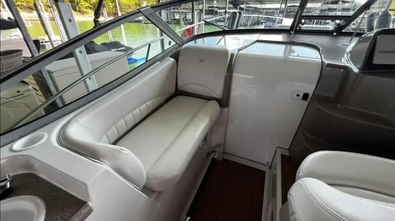 Slide: The Image of Interior of 2003 Four Winns 328 Vista boat with white seating and wood flooring. - 12