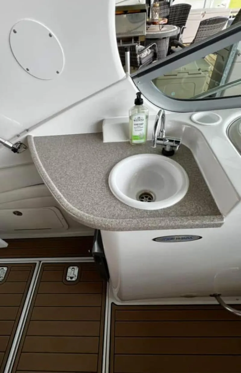 Slide: The Image of 2003 Four Winns 328 Vista boat sink area with countertop and faucet. - 13