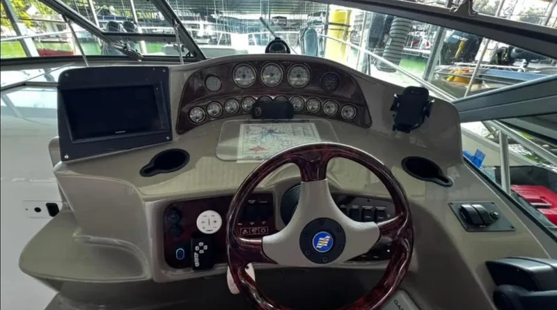 Slide: The Image of 2003 Four Winns 328 Vista boat dashboard with steering wheel and navigation instruments. - 15