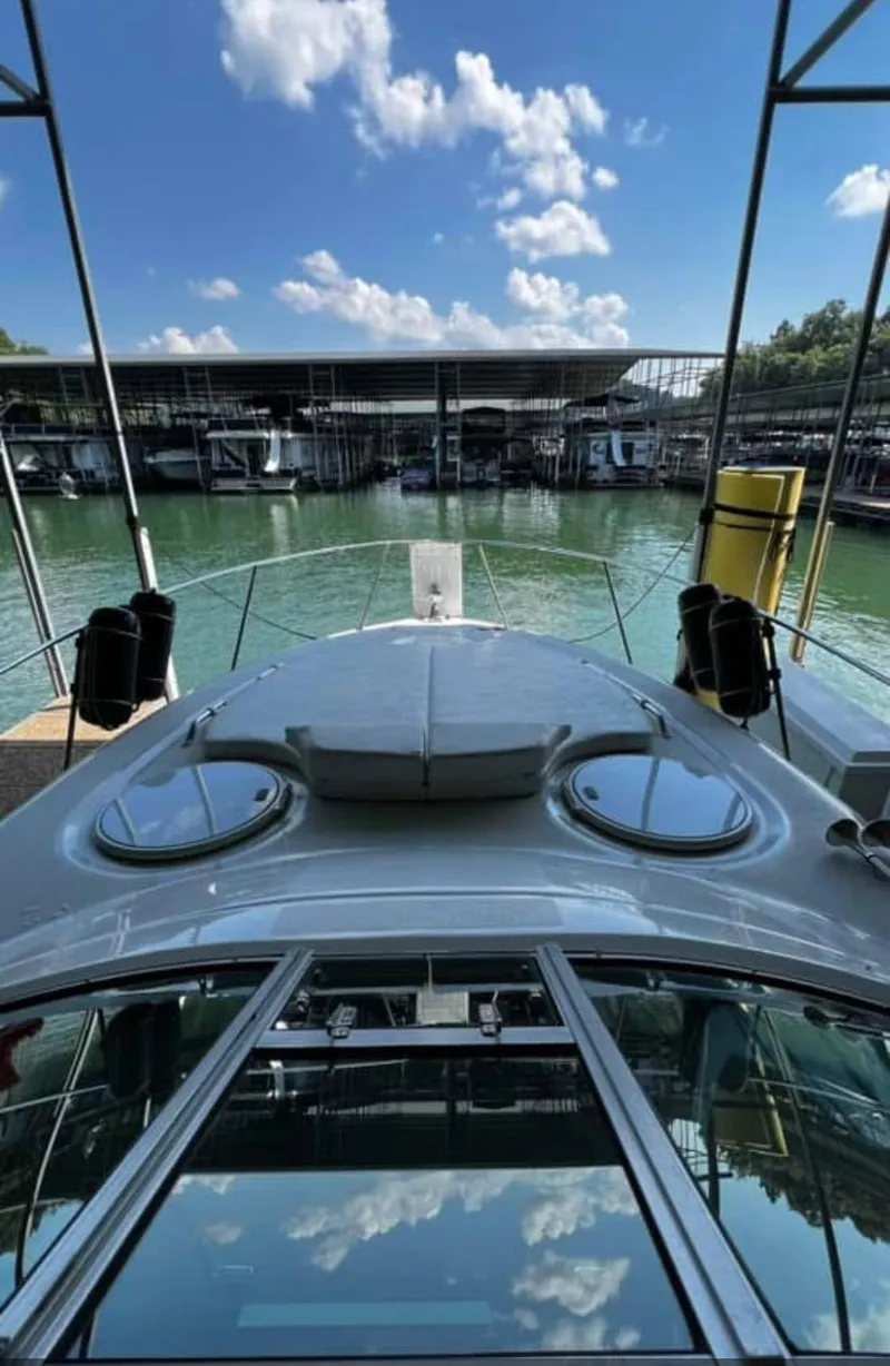 Slide: The Image of 2003 Four Winns 328 Vista yacht docked at marina under blue sky. - 17