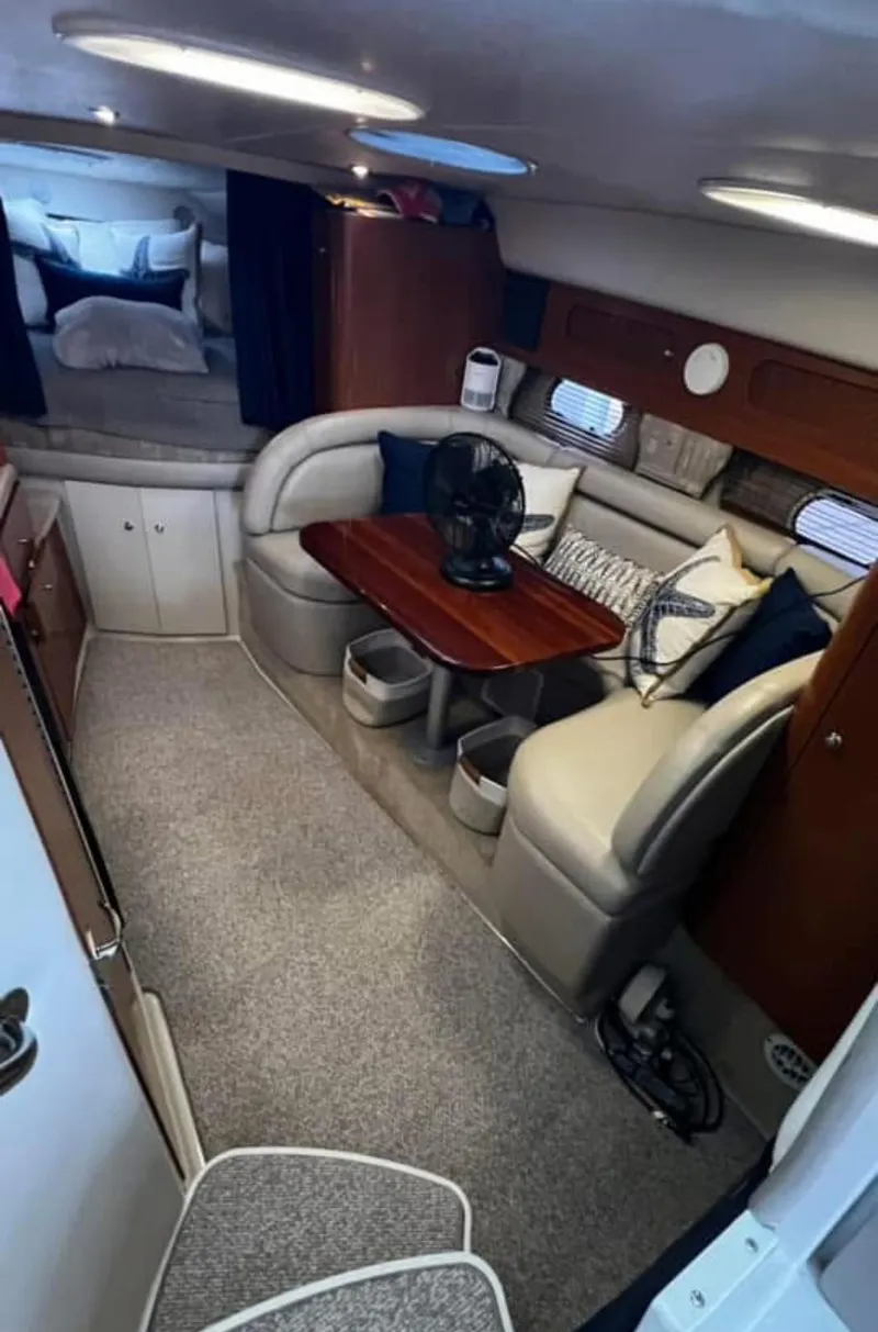 Slide: The Image of Interior of 2003 Four Winns 328 Vista boat with cozy seating and table. - 18