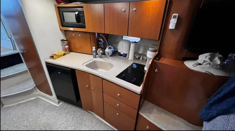 Slide: The Image of 2003 Four Winns 328 Vista yacht kitchen with microwave, sink, and stove. - 22