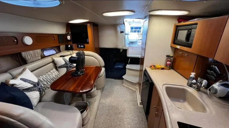 Slide: The Image of Interior of 2003 Four Winns 328 Vista yacht with cozy seating and kitchenette. - 23