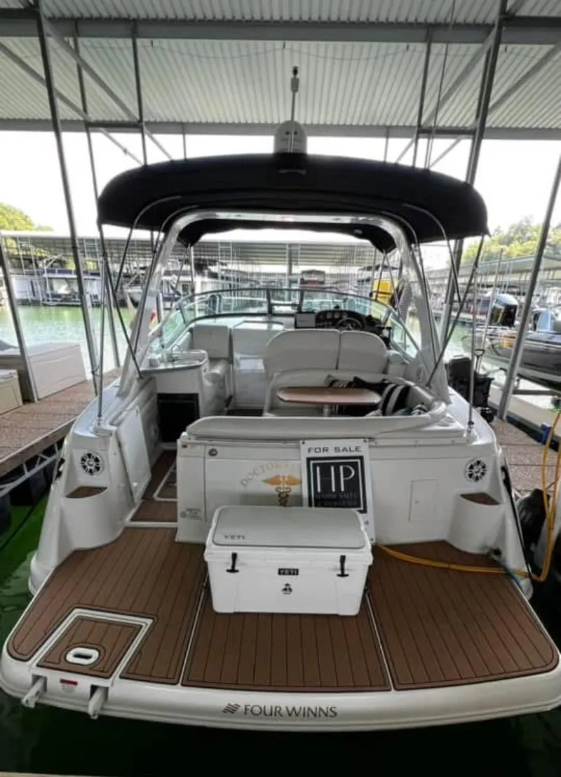 Slide: The Image of 2003 Four Winns 328 Vista boat for sale, docked under a covered marina. - 3