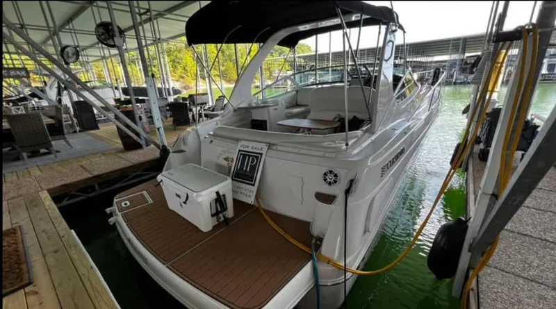 Slide: The Image of 2003 Four Winns 328 Vista boat docked, for sale, with covered seating area. - 6