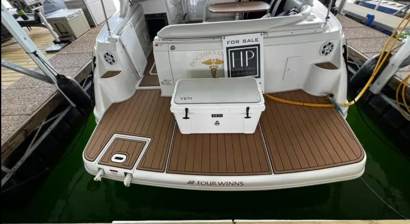 Slide: The Image of 2003 Four Winns 328 Vista boat with teak deck and Yeti cooler, docked and for sale. - 7