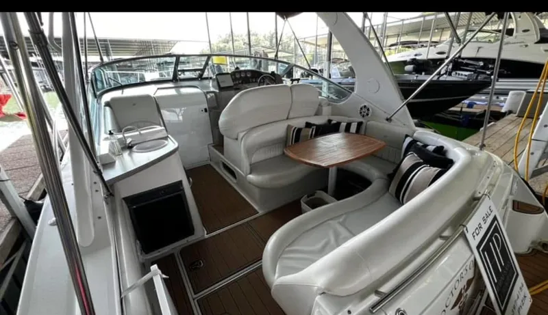 Slide: The Image of 2003 Four Winns 328 Vista boat interior with seating and table, for sale sign visible. - 8