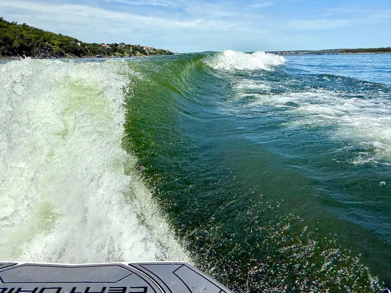 Slide: The Image of Wake surfing wave behind 2017 Centurion Ri237 boat on a sunny day. - 11
