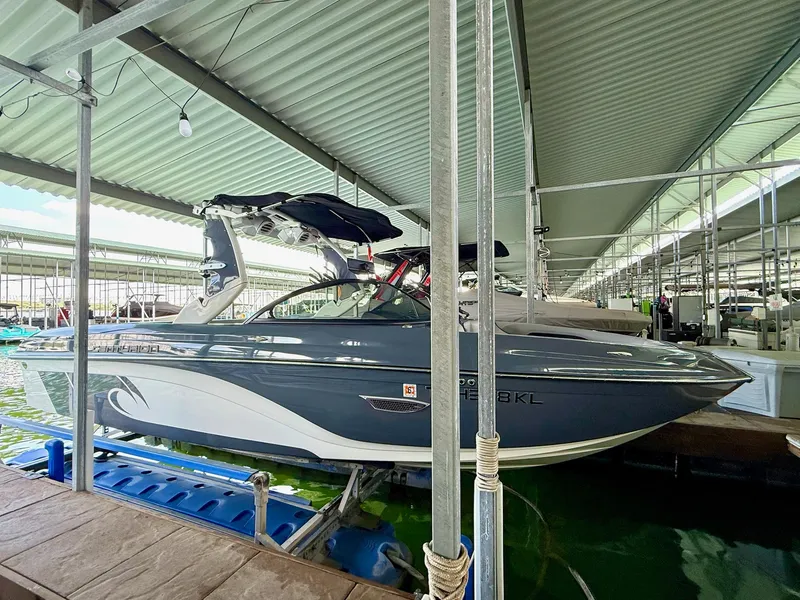 Slide: The Image of 2017 Centurion Ri237 boat docked in a covered marina. - 15