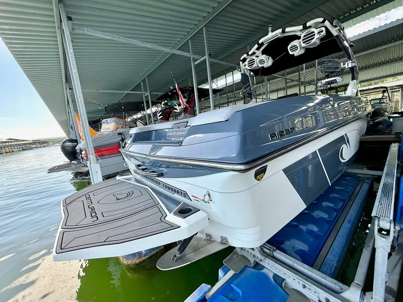 Slide: The Image of 2017 Centurion Ri237 boat docked, showcasing sleek design and advanced features. - 16