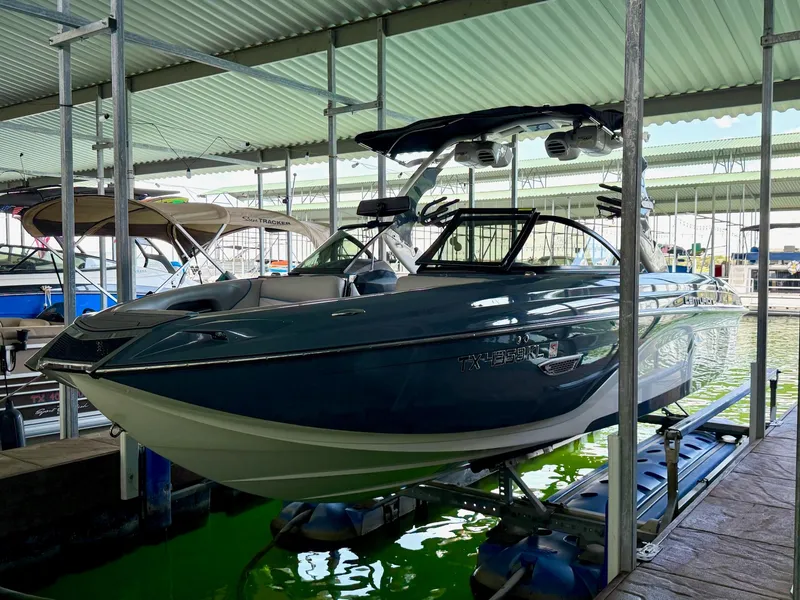 Slide: The Image of 2017 Centurion Ri237 boat docked in covered marina, side view. - 18