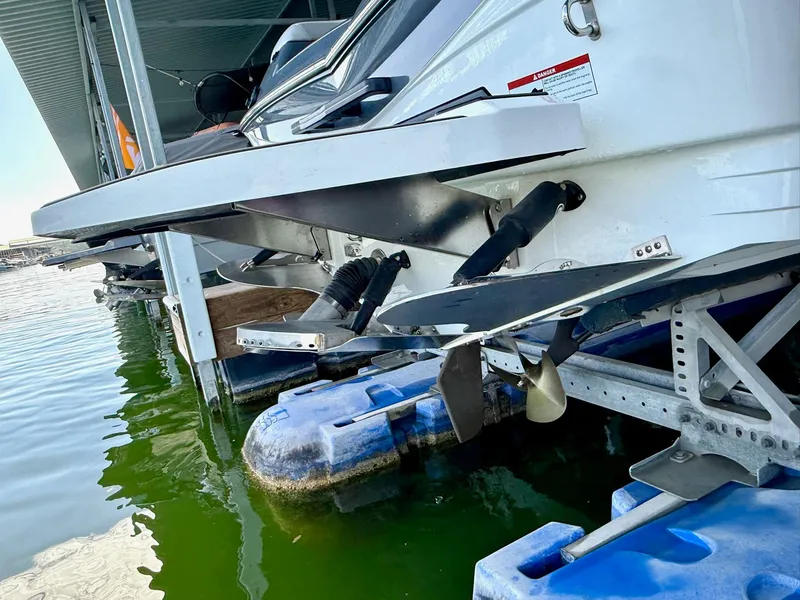 Slide: The Image of 2017 Centurion Ri237 boat docked, showing propeller and hull details. - 20