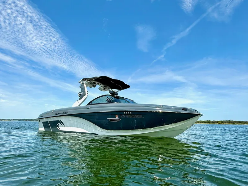 Slide: The Image of 2017 Centurion Ri237 boat on calm water under a clear blue sky. - 3