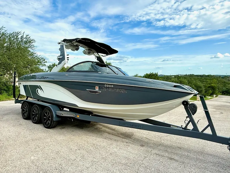 Slide: The Image of 2017 Centurion Ri237 boat on trailer, parked outdoors under a blue sky. - 30