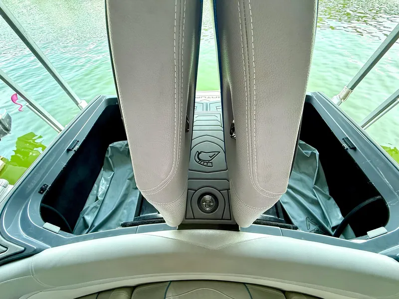 Slide: The Image of 2017 Centurion Ri237 boat interior storage compartments open by the water. - 39