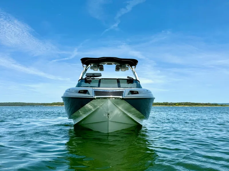 Slide: The Image of 2017 Centurion Ri237 boat on calm water under clear blue sky. - 4