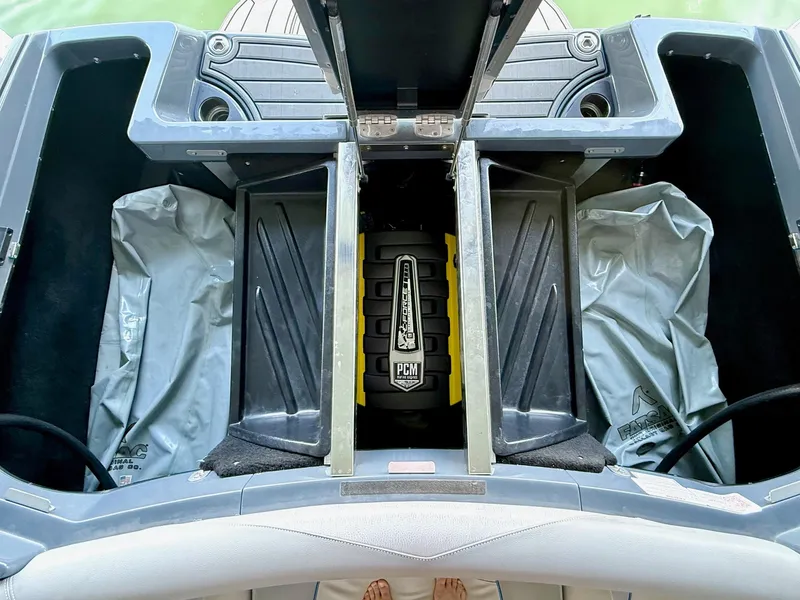 Slide: The Image of 2017 Centurion Ri237 boat engine compartment with PCM engine and storage areas. - 40