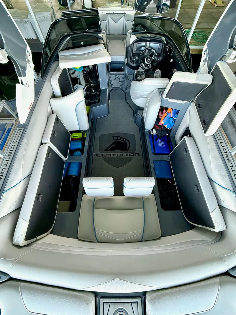 Slide: The Image of 2017 Centurion Ri237 boat interior with open storage compartments and sleek seating design. - 41