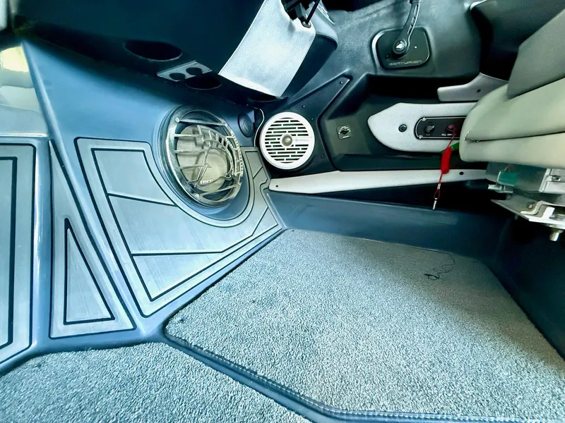 Slide: The Image of Interior of a 2017 Centurion Ri237 boat, featuring speaker and carpeted flooring. - 47