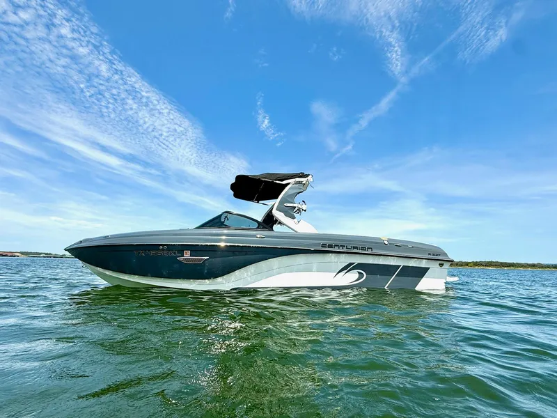 Slide: The Image of 2017 Centurion Ri237 boat on calm water under a clear blue sky. - 6