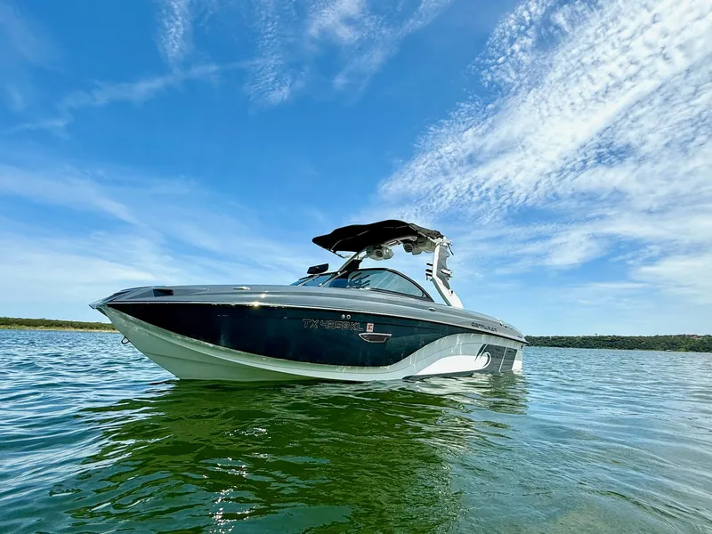 Slide: The Image of 2017 Centurion Ri237 boat on calm water under a clear blue sky. - 8