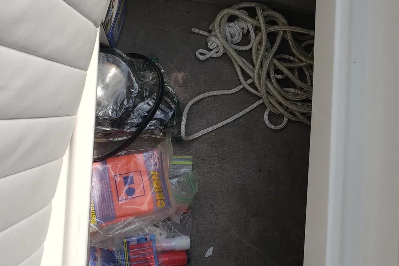 Slide: The Image of 2006 Ebbtide 2300 BRL boat dashboard with wood-trimmed steering wheel and instrument panel. - 11