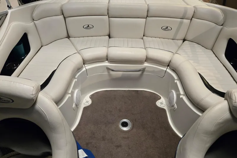Slide: The Image of 2006 Ebbtide 2300 BRL boat interior with white cushioned seating and carpeted floor. - 14