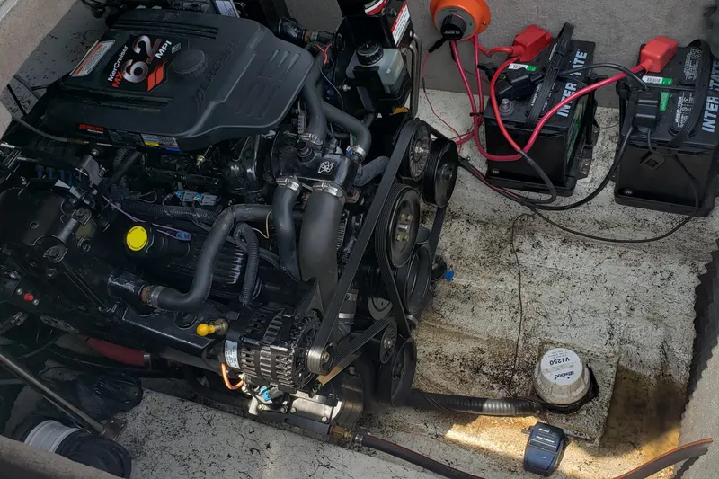 Slide: The Image of Engine compartment of a 2006 Ebbtide 2300 BRL boat with batteries and wiring. - 16