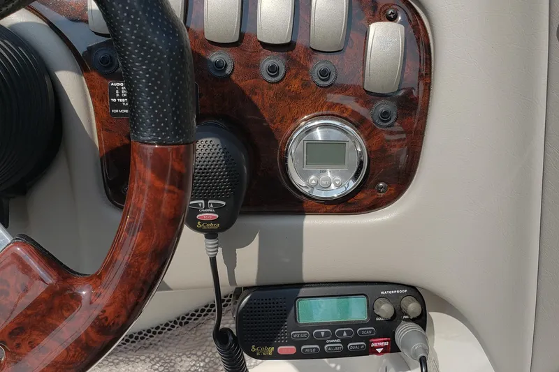 Slide: The Image of 2006 Ebbtide 2300 BRL boat in storage, featuring sleek design and dual-axle trailer. - 2